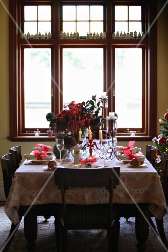 A table laid for Christmas dinner in front of a large window