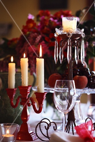 A Christmas table with various candle sticks