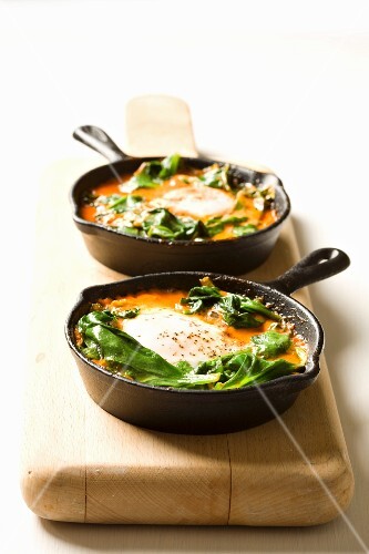 Shakshouka - poached eggs with tomatoes and spinach