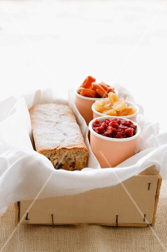 A teacake and dried fruits in cups