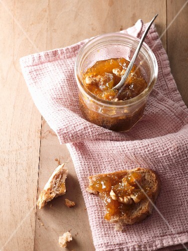 Fig and walnut jam in a glass and on a slice of bread