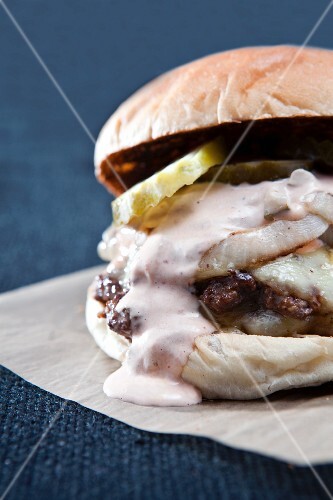Double Cheeseburger with Grilled Onions, Pickles and Garlic Aioli on a Bun