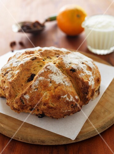 Soda bread with raisins on a wooden board