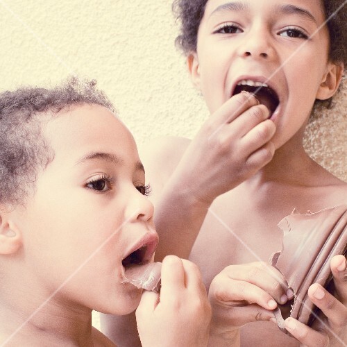 A girl and a boy eating chocolate