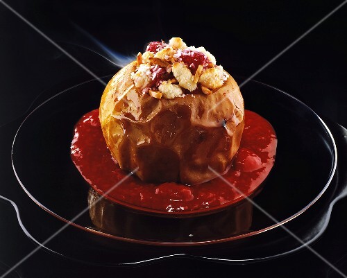 Baked apple with almond & coconut filling & raspberry sauce