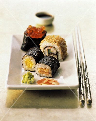 Assorted Sushi with Green Wasabi Paste on a Rectangular Plate