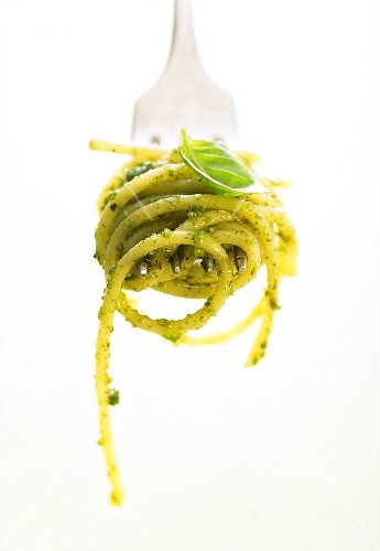 A forkful of spaghetti with pesto
