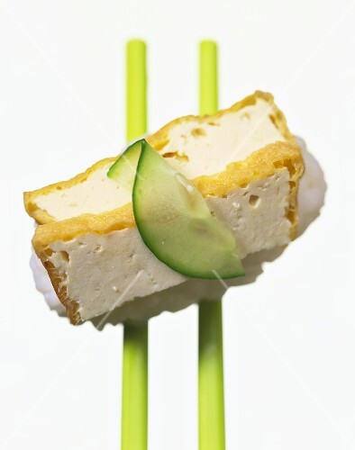 Nigiri-sushi with baked tofu strips and slice of cucumber