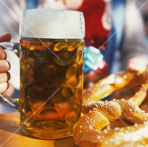 Tankard and two pretzels on table at Oktoberfest
