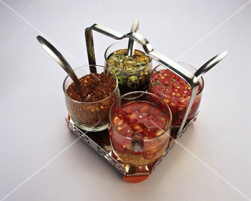 Stand with three chili sauces and chili powder