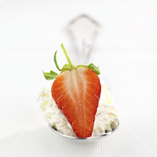 Strawberry and cream on spoon
