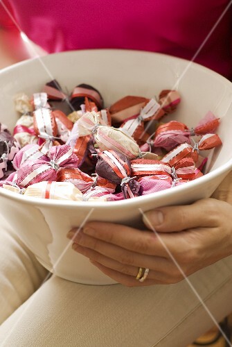 Woman holding bowl of sweets