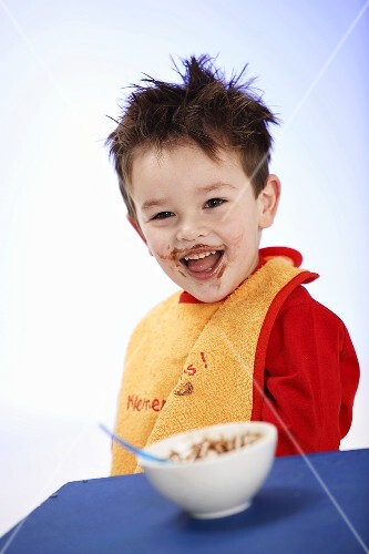 Small boy in bib after eating