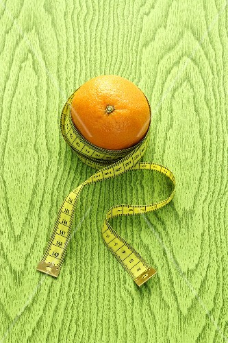 An orange with a tape measure