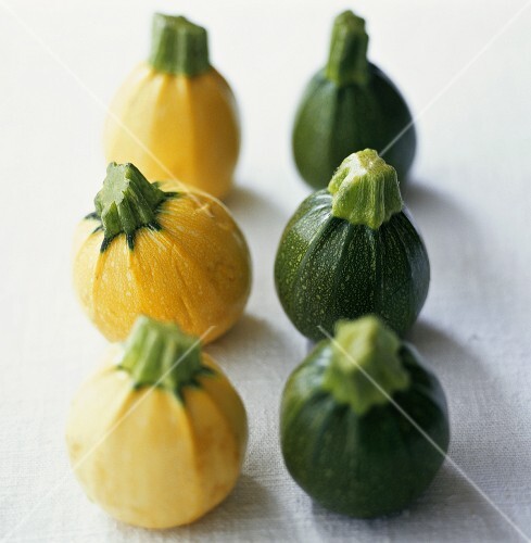 Small, round, yellow and green courgettes