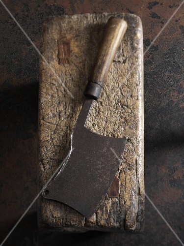 An old meat cleaver on a piece of wood