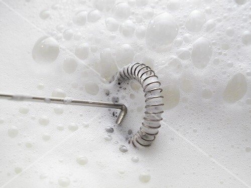 Frothing milk with a whisk