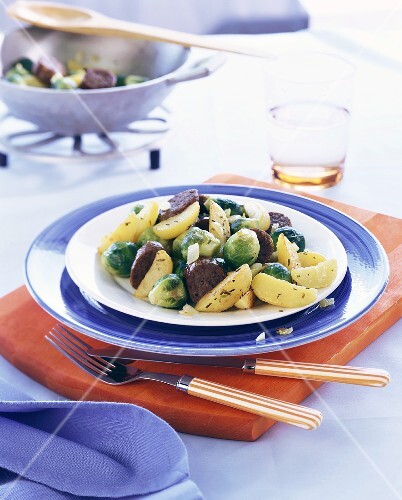 Pan-cooked potato & Brussels sprout dish with sausage pieces