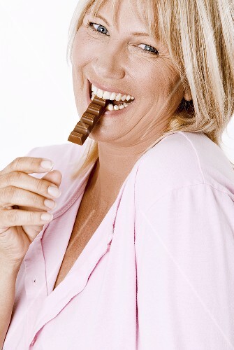 Woman eating a chocolate bar