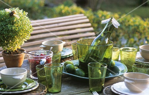 Soup bowls and wine on laid table out of doors