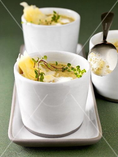 Lentil soup with thyme and cheese in two soup cups