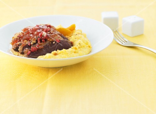 Duck breast with roasted red almonds and apricot polenta