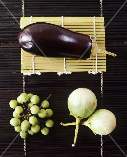 Three different types of aubergine on bamboo mat