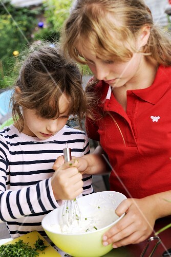 Two girls preparing chive quark