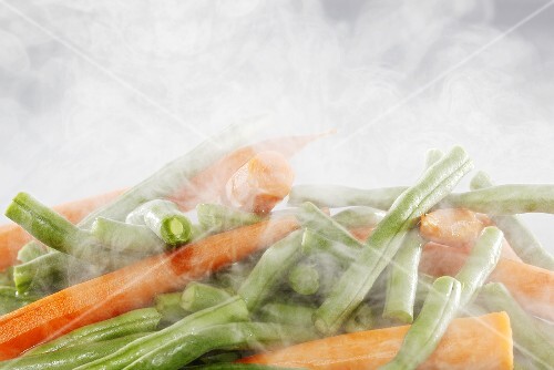Beans and carrots being steamed