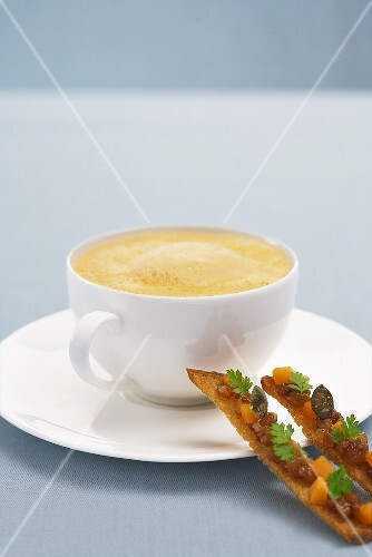 Pumpkin foam soup with bread sticks