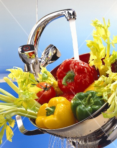 Washing vegetables under running water
