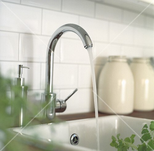 Water running into a modern ceramic sink
