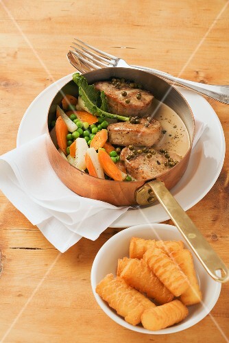 Pork medallions with pepper sauce and garden vegetables