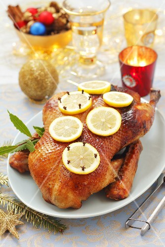 Roast duck with lemon slices and cloves