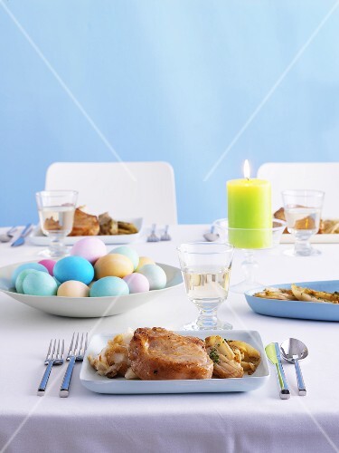Pork chop and Easter eggs on Easter table