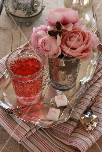 Fruit tea and a bouquet of faux roses
