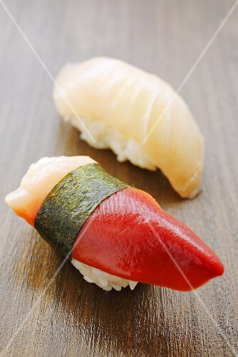 Two different nigiri sushi (shellfish and mackerel)