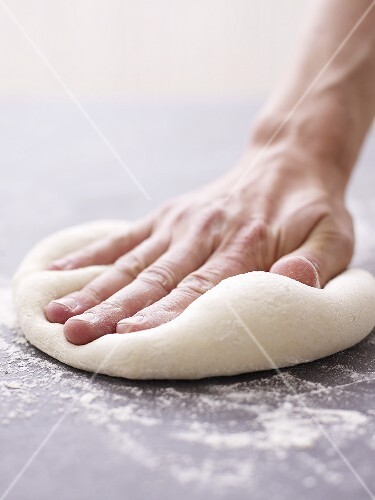 Kneading pizza dough