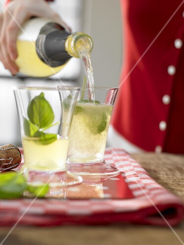 Lemon cocktail made with limoncello, basil & sparkling wine