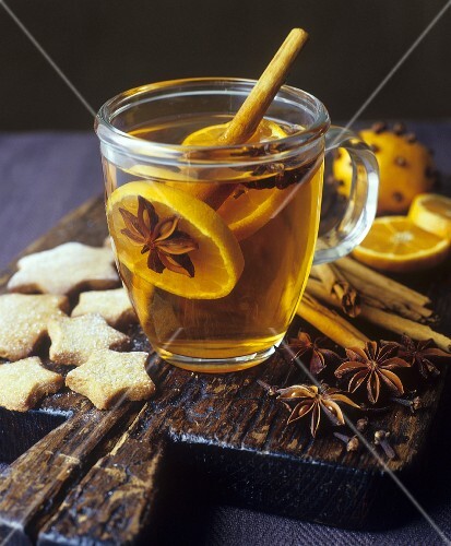 Grog with orange slices and spices, star biscuits