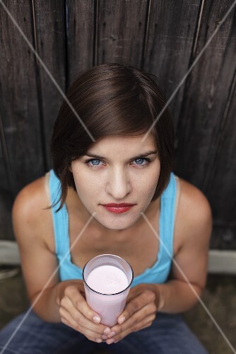 Young woman holding milkshake