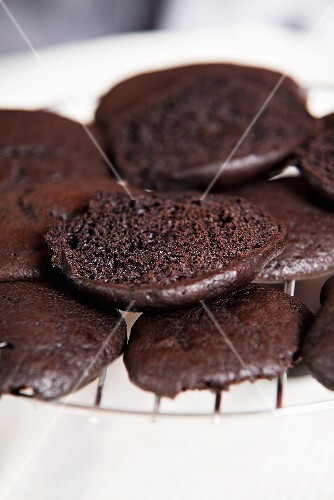 Chocolate whoopie pie halves on a wire rack