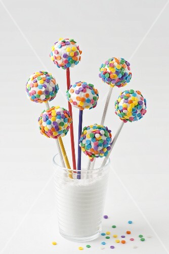 Cake pops with white icing and colourful sugar strands