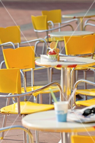 Chairs and tables in front of an ice cream cafe