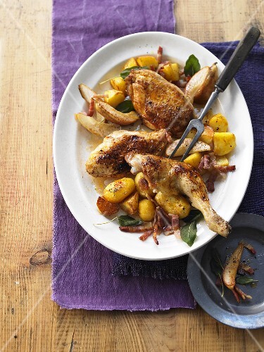 Roast chicken with bacon, pears and potatoes
