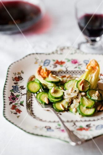 Courgette and courgette flowers with roasted pine nuts