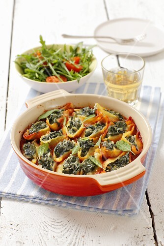 Conchiglie (pasta shells) with spinach filling and tomato sacue