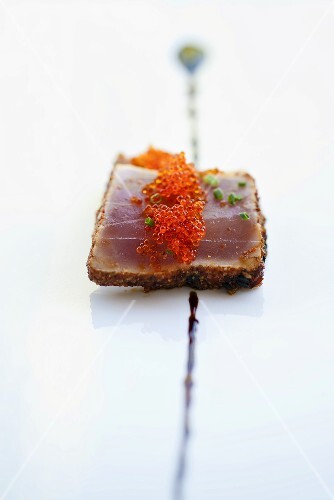 Salmon caviar on top of a slice of tuna