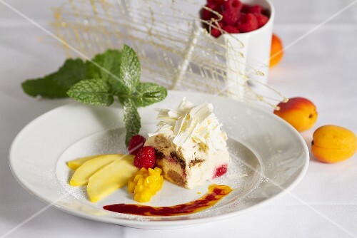 Tiramisu with white chocolate flakes and a fruit garnish
