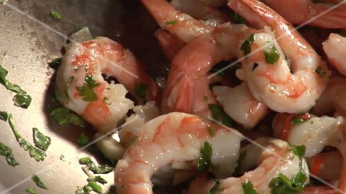 Prawns with garlic, chilli and herbs in a wok